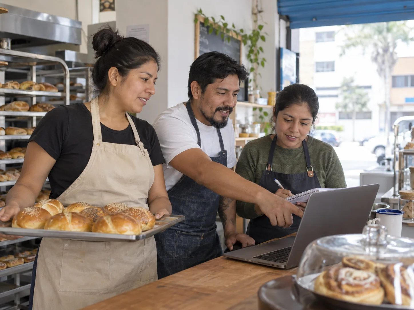 A bakery team shares customer orders before opening.